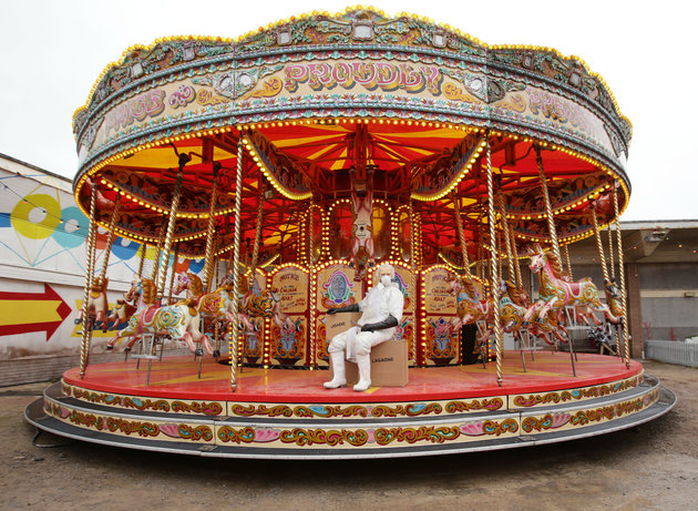 An merry-go-round installation during the press view for artist Banksy's biggest show to date, entitled 'Dismaland', at Tropicana in Western-super-Mare, Somerset.